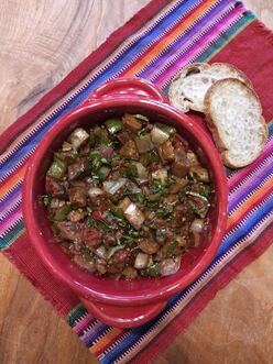 A bowl of fresh garden salsa with bread