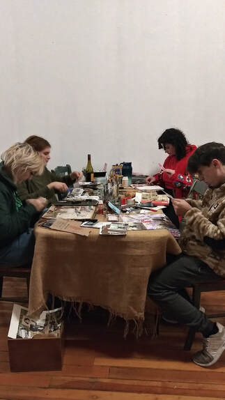 A group scrapbooking around a table at Interwoven