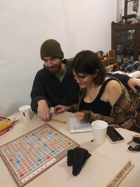 Two people playing Scrabble on a Monday night at Interwoven