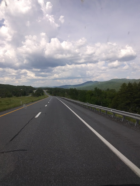 A New Hampshire highway under a cloud-filled sky